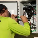 Authorized installer wiring an electrical panel
