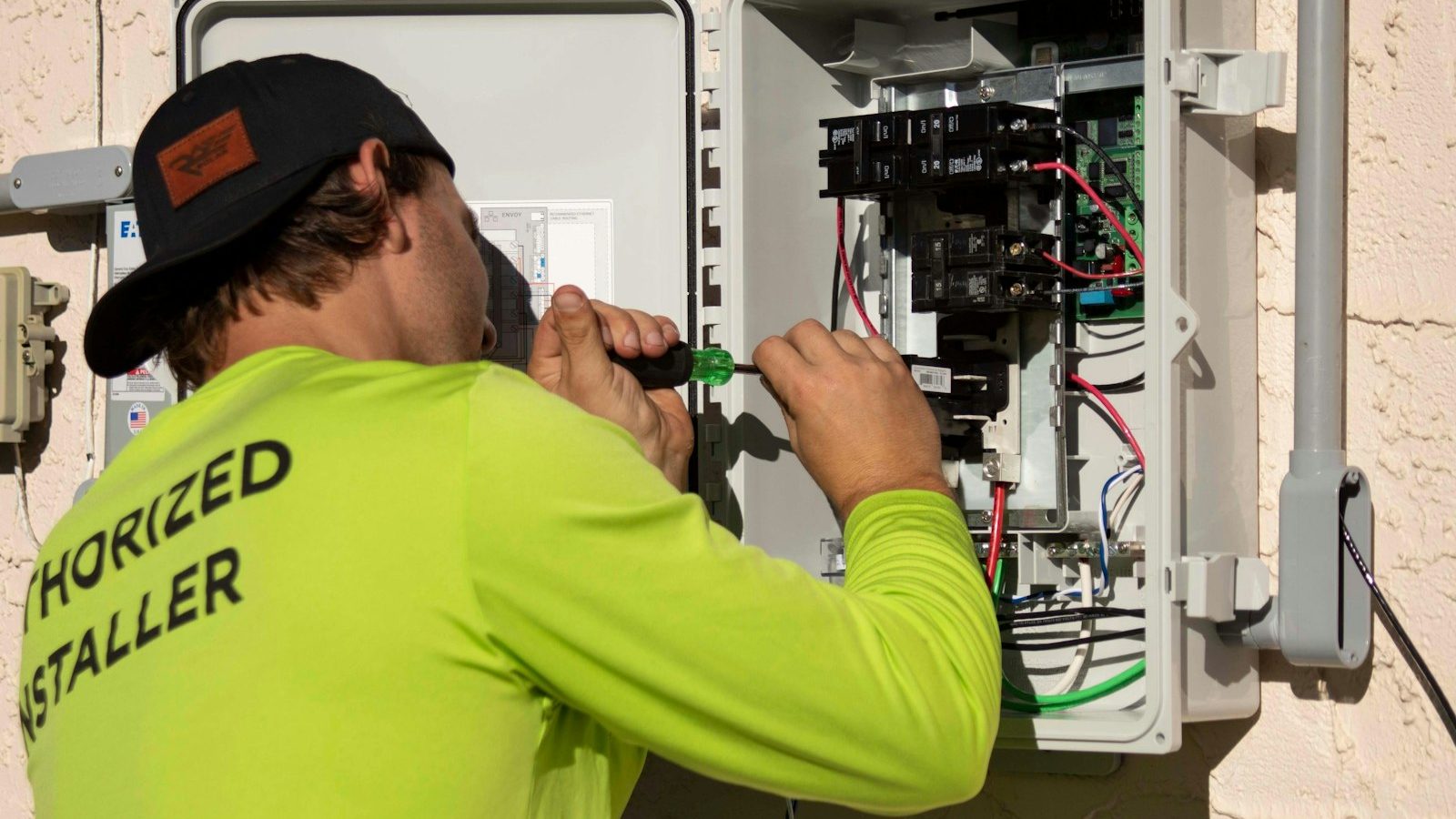 Authorized installer wiring an electrical panel