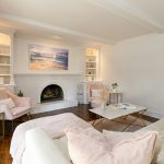 Bright living room with white walls and fireplace