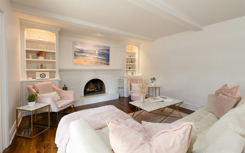 Bright living room with white walls and fireplace