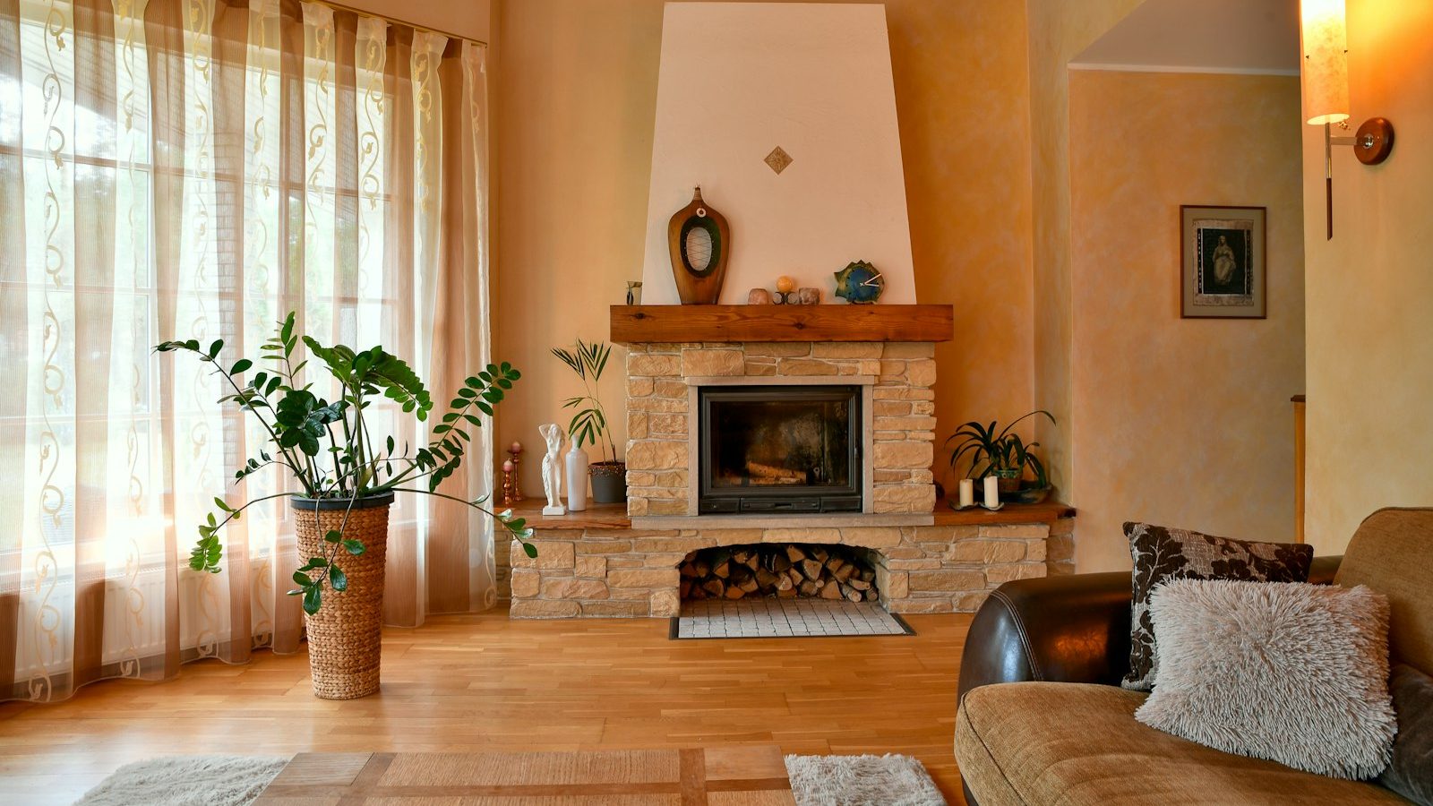 Cozy living room with a stone fireplace and large window