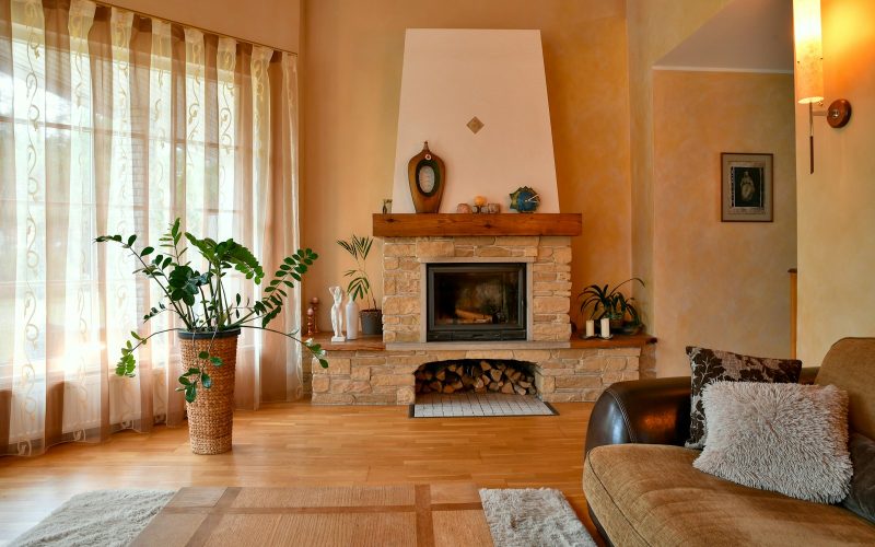 Cozy living room with a stone fireplace and large window