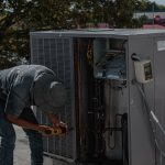 HVAC technician servicing a rooftop unit