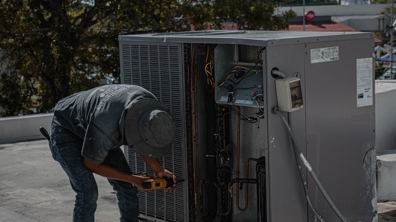 HVAC technician servicing a rooftop unit