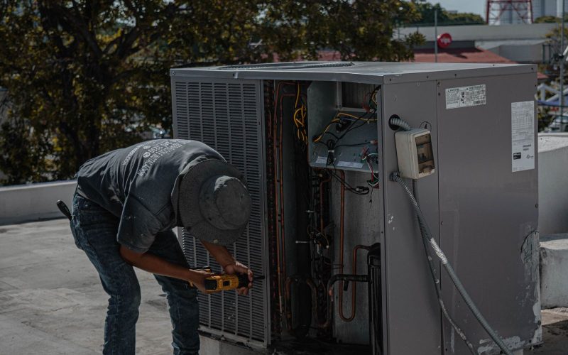 HVAC technician servicing a rooftop unit