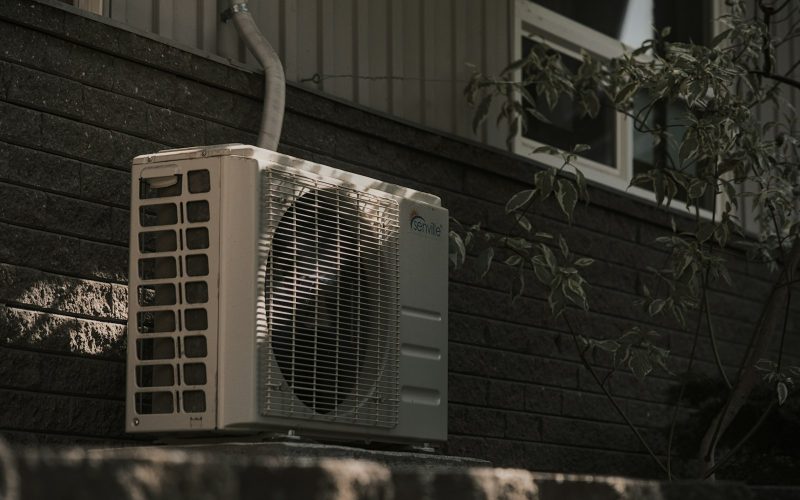 Mini-split outdoor condenser mounted on a brick wall