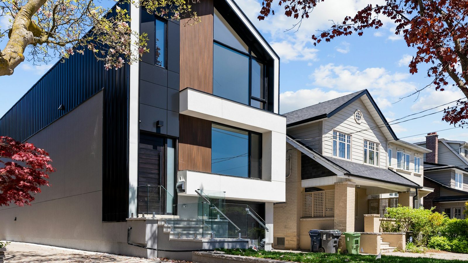 Modern house beside a traditional home