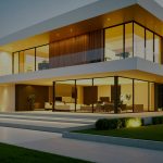 Modern house exterior glowing with lights at dusk