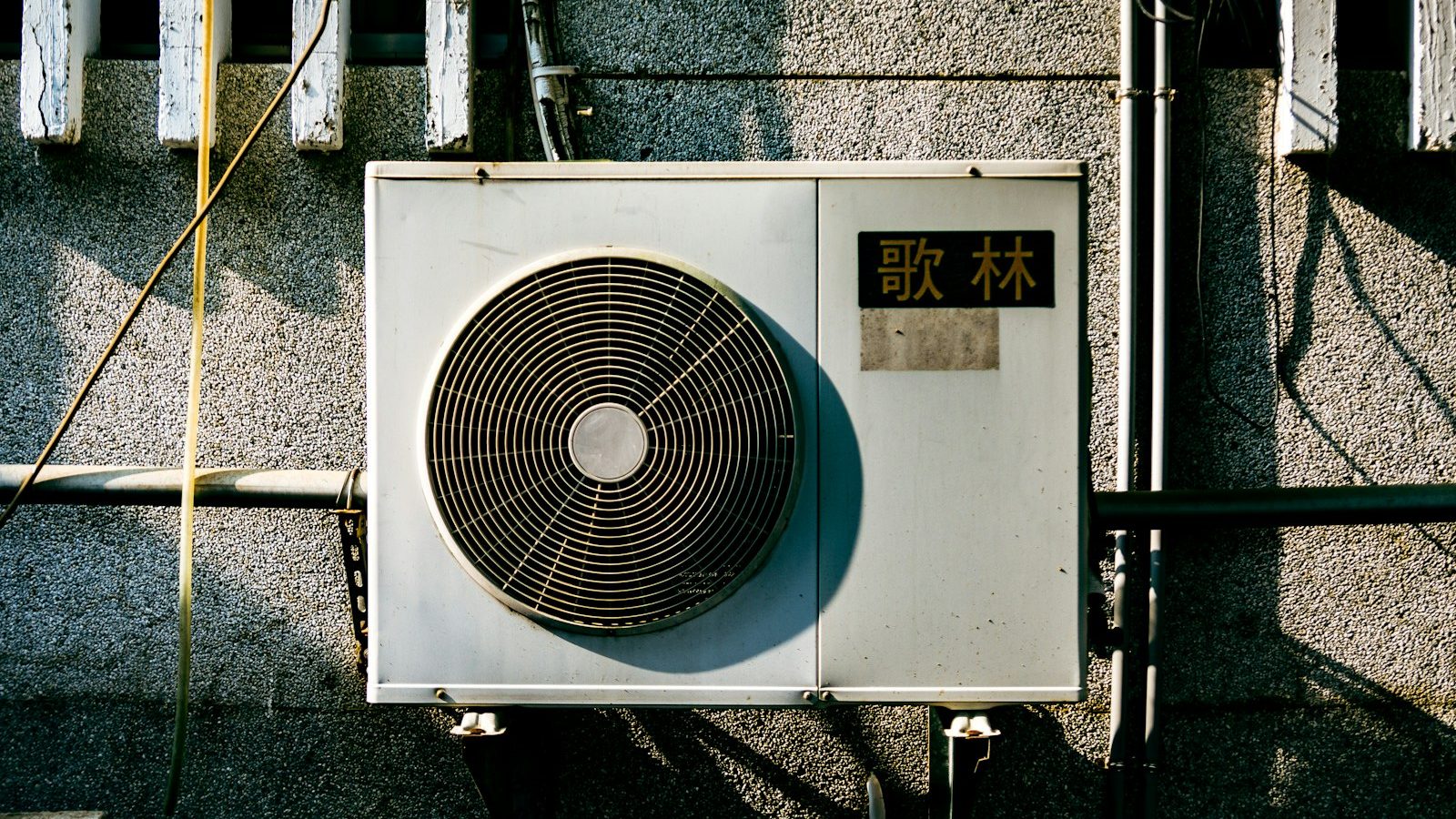 Older wall-mounted air conditioner condenser