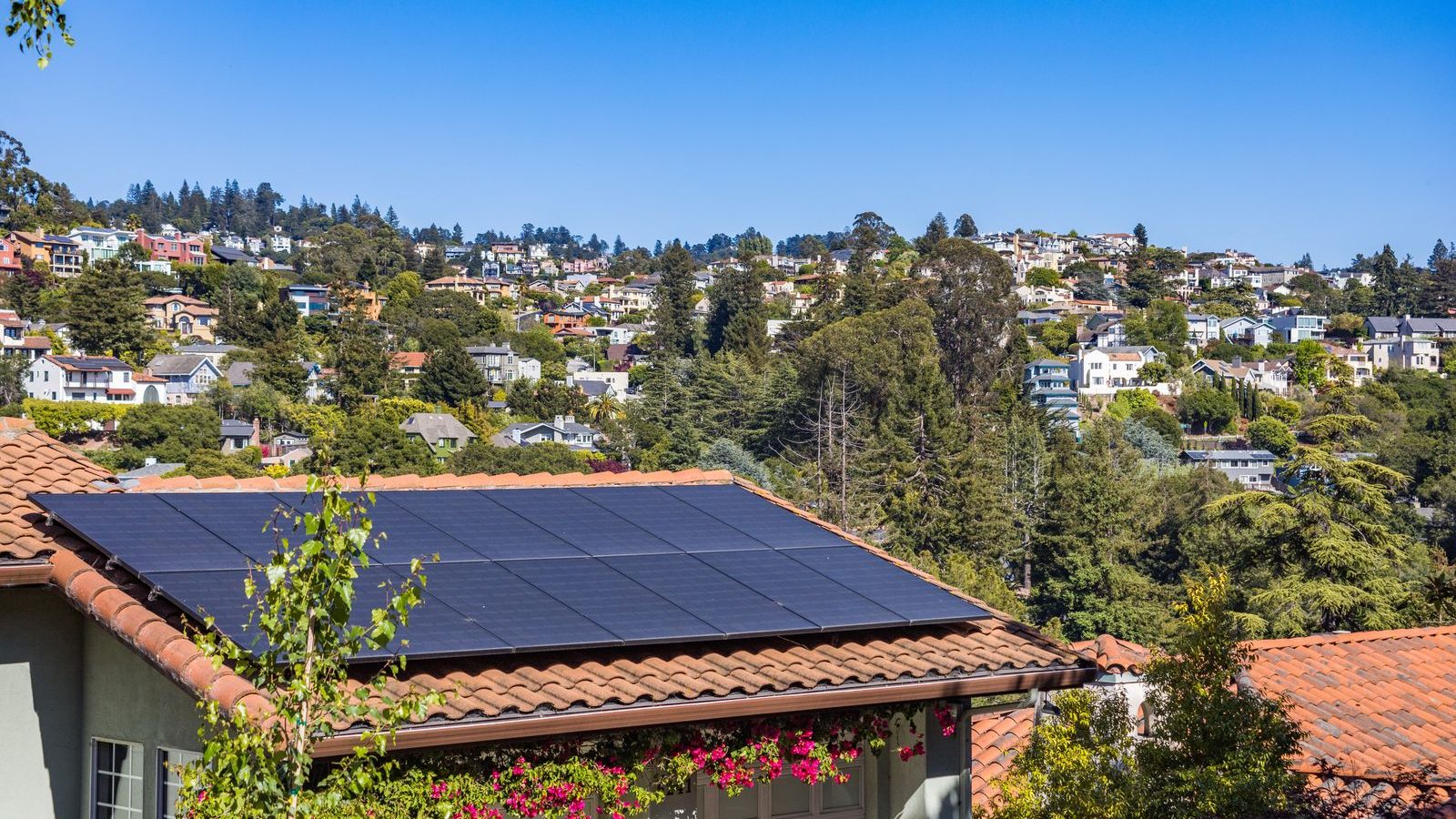 Suburban home with solar panels on a hillside