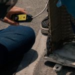 Technician testing a heat pump with a multimeter