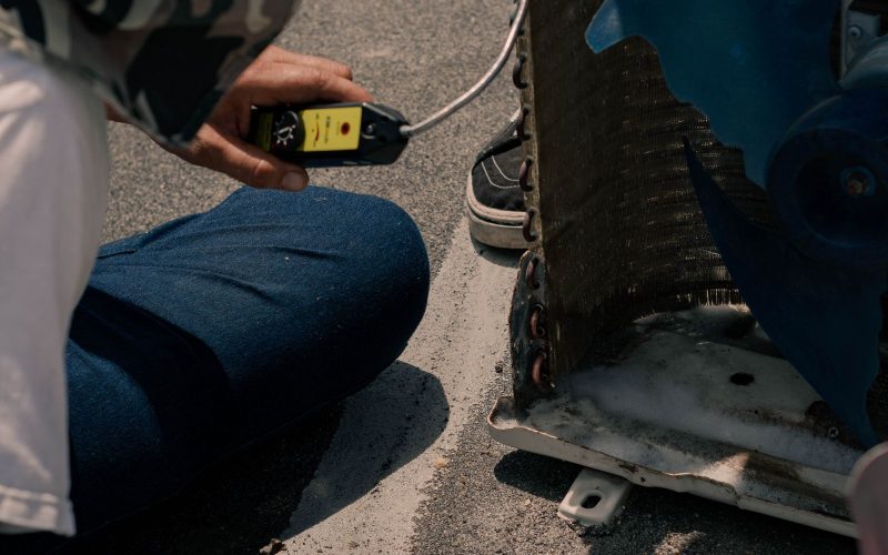 Technician testing a heat pump with a multimeter