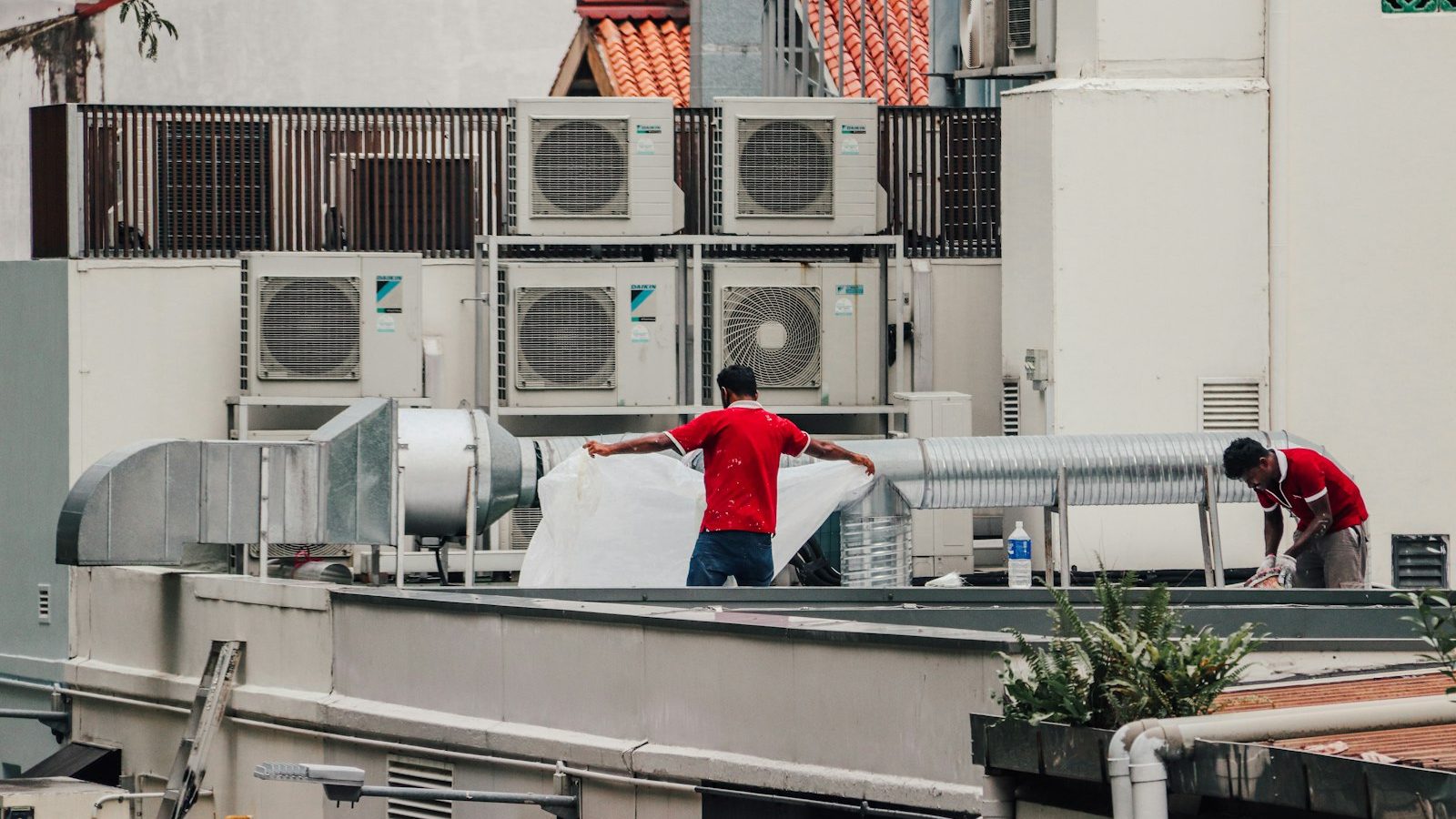 Technicians on a roof with HVAC units