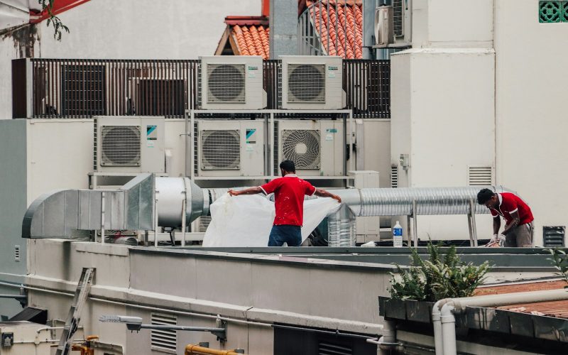 Technicians on a roof with HVAC units