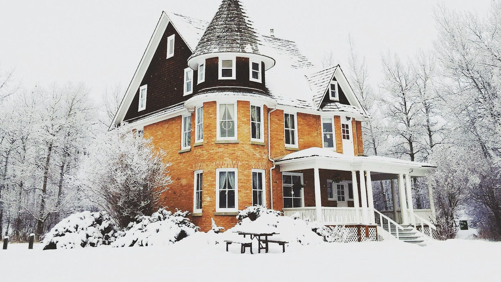 Victorian house surrounded by snow