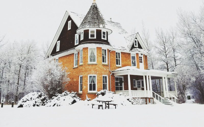 Victorian house surrounded by snow