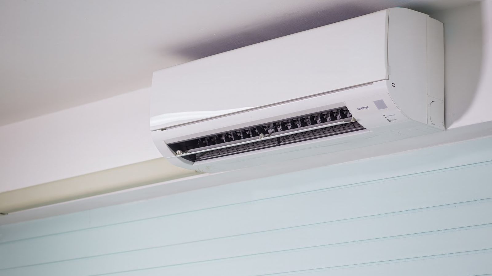 White ductless indoor unit near the ceiling