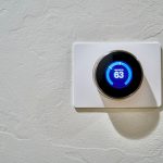 White round thermostat set to 62 degrees