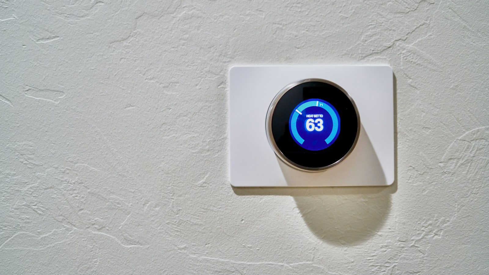 White round thermostat set to 62 degrees