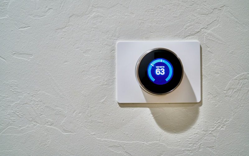 White round thermostat set to 62 degrees